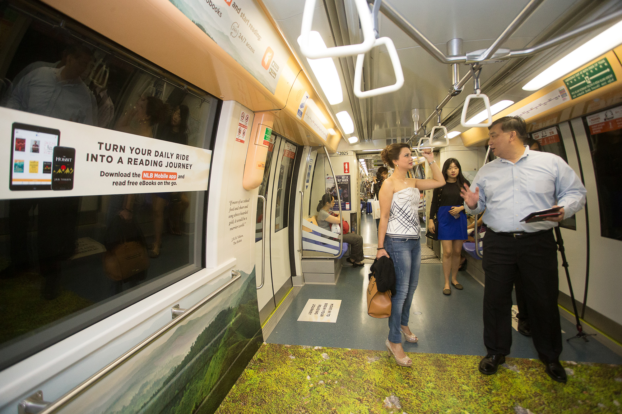 Siow Shong Seng, Director of Technology & Service Innovation, National Library Board (NLB) bringing Michelle Martin, NLB Reading Ambassador and radio presenter of 938LIVE, on a tour of the library-themed train at the launch event for NLB’s new mobile app.